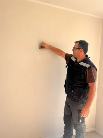 Inspector revisando la superficie de un muro